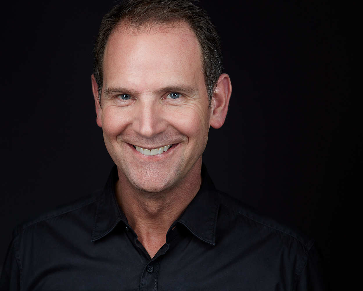 Professional headshot on grey