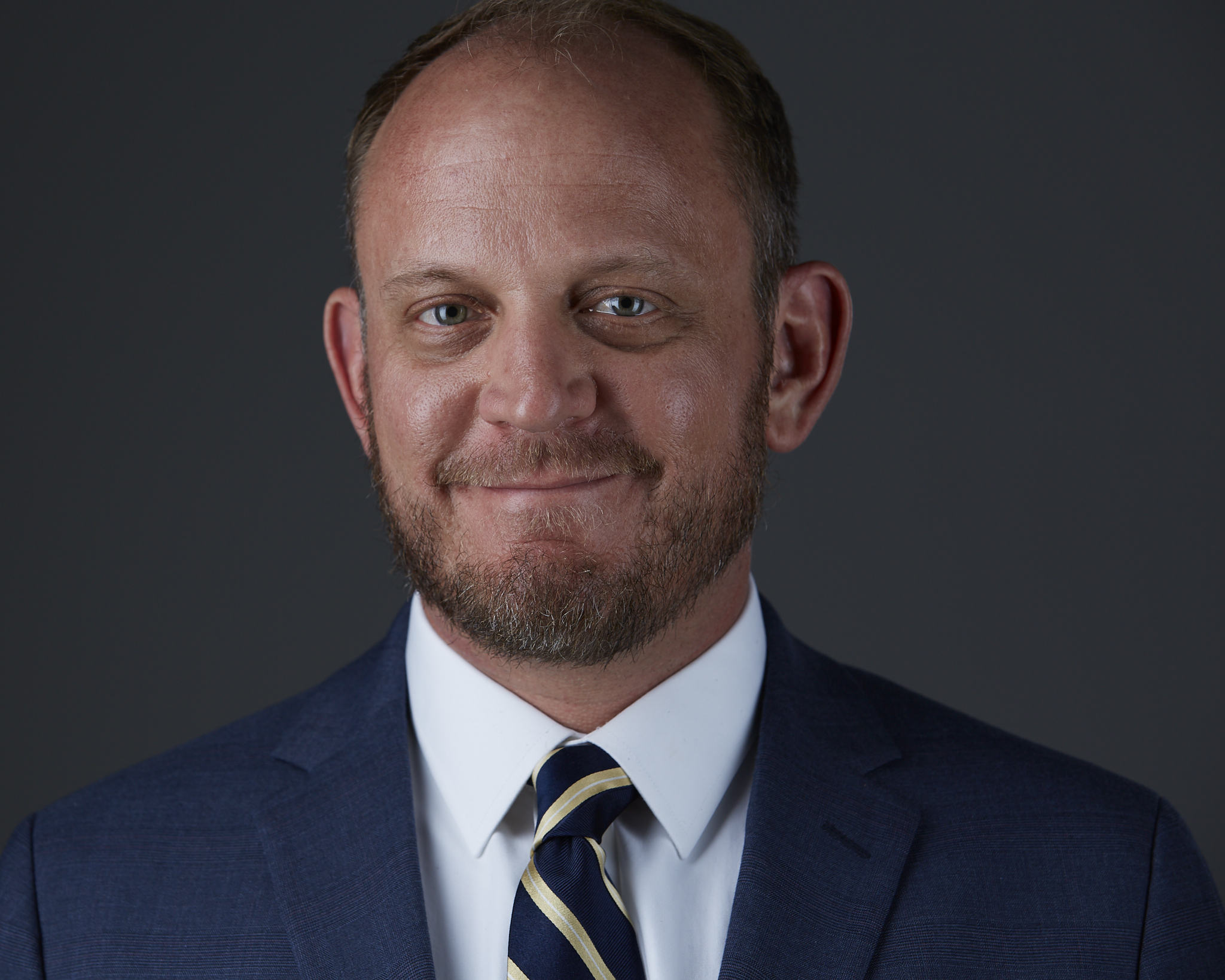 Professional headshot with glasses