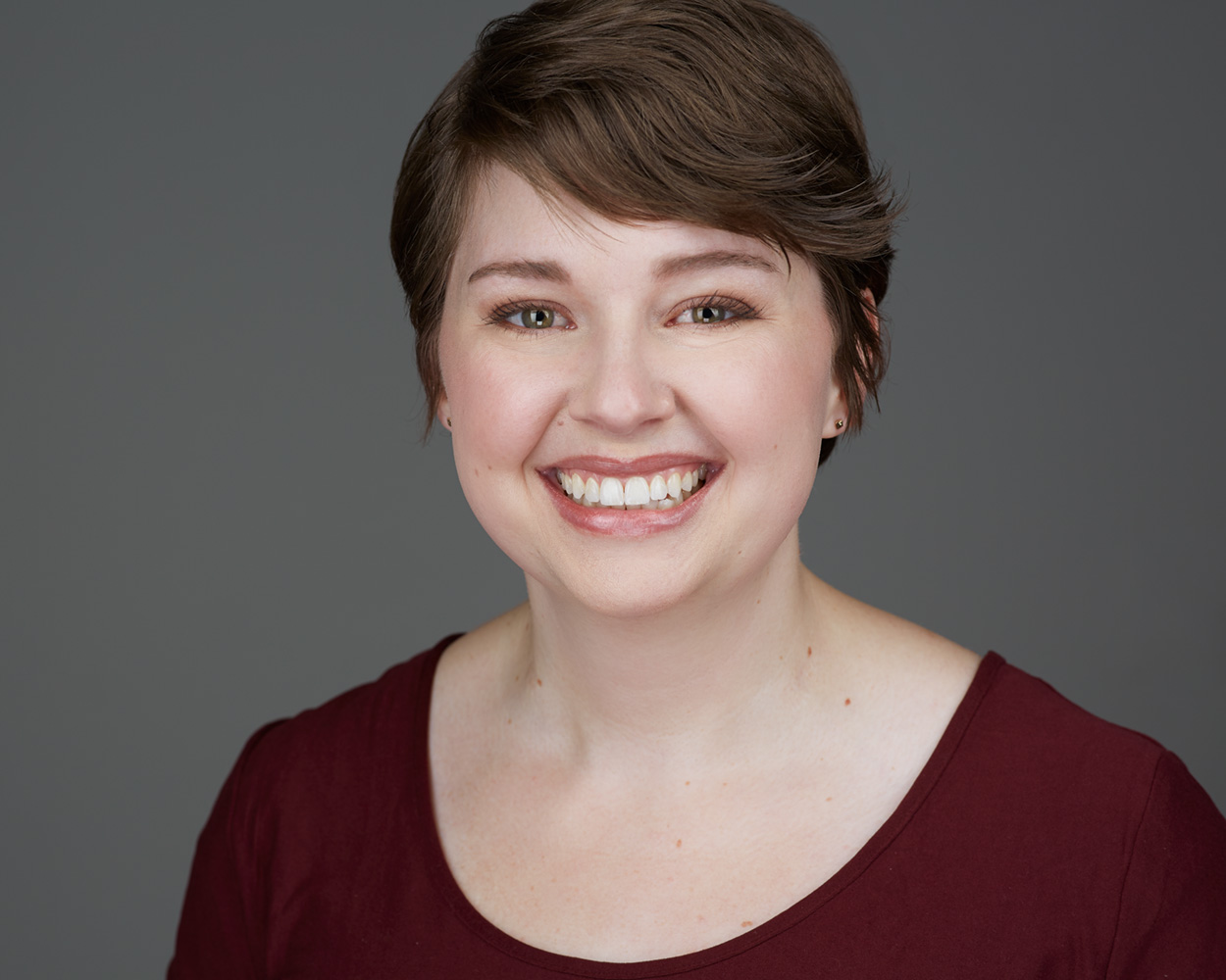 Corporate headshot — short hair, red top