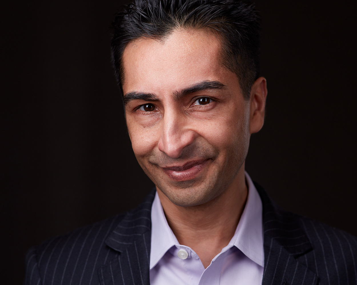 Editorial headshot — dark background